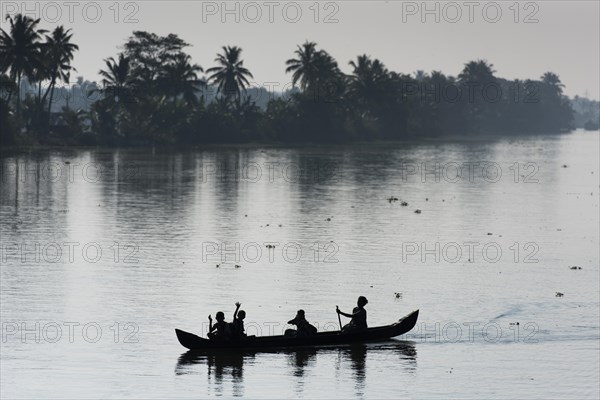 Woman taking children to school in a small boat