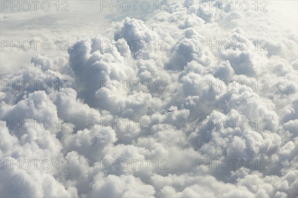 Cloud formations with a small passenger aircraft