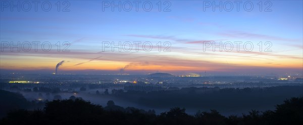 View from the Halde Norddeutschland spoil tip onto the Lower Rhine and the western Ruhr district at dawn