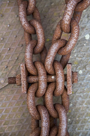 Rusty large metal chain and bolt