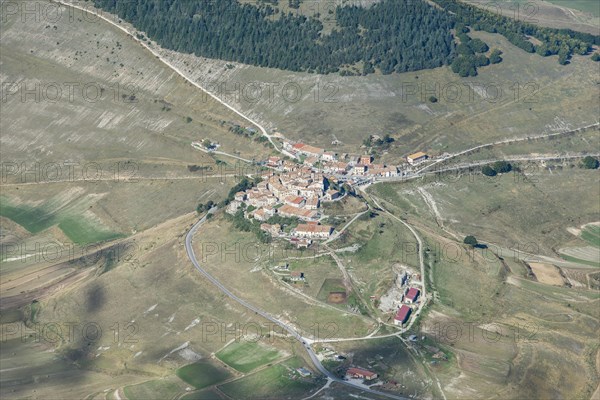 Aerial view of Piano Grande plateau and village of Castelluccio di Norcia