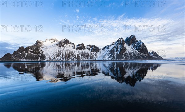 Mountain Vestrahorn with water reflection in the bay of Hornsvik