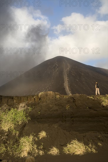 Person in front of Mount Yasur volcano