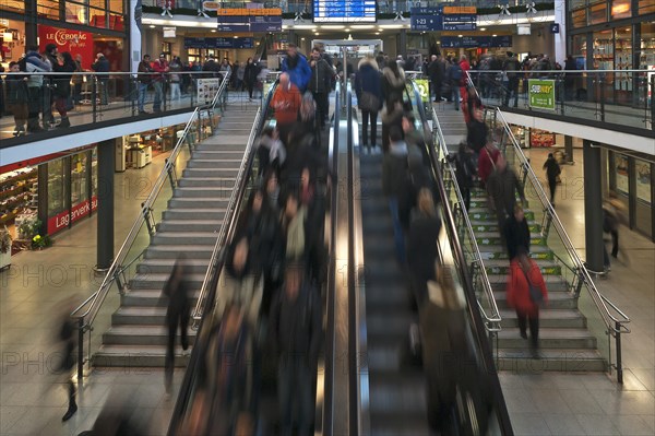 People in motion on escalators in the main station