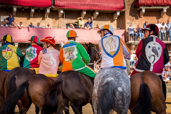 Jockeys from six different districts waiting for the start of Palio di Siena horse race on Piazza del Campo