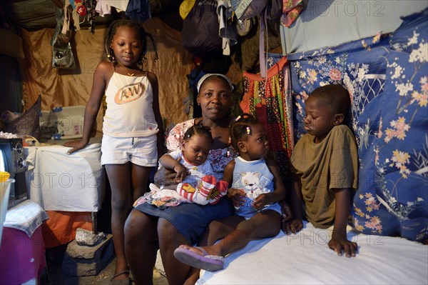 Woman with four children in a shack