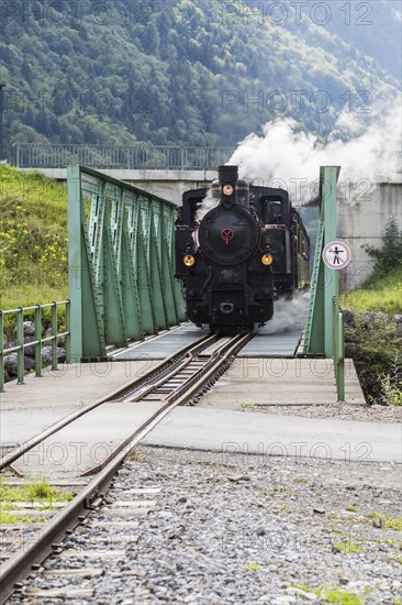 Bregenz Forest Railway with steam locomotive crossing steel bridge
