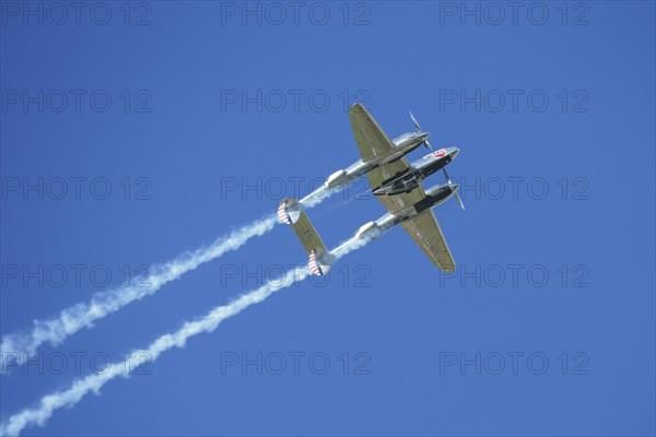 A Lockheed P-38 Lightning flying in a flight display during the Red Bull Air Race