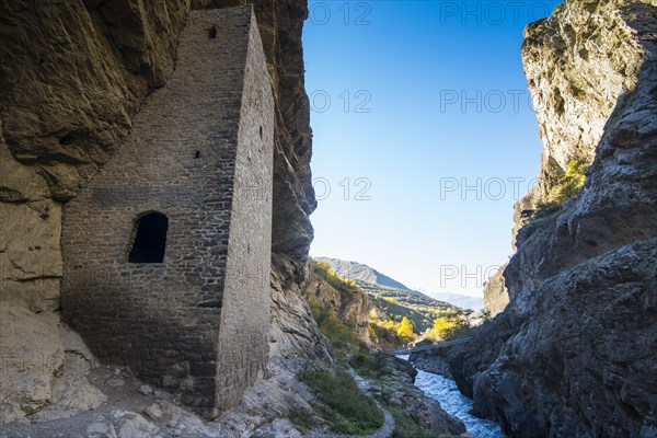 Chechen watchtowers under overhanging cliff on the Argun river