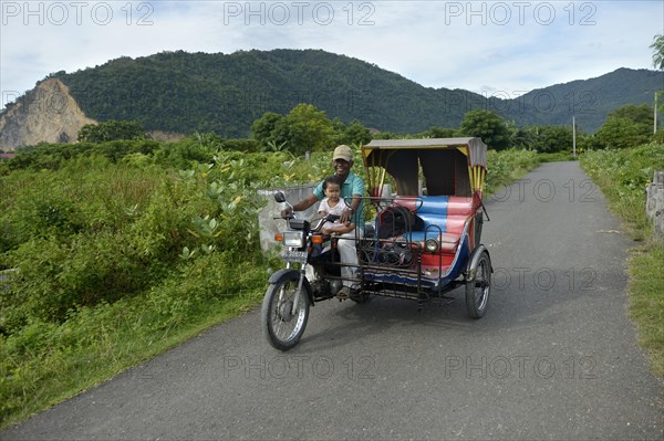 Man with child on motorcycle Rick Shah