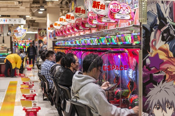 Players sit at slot machines in a casino