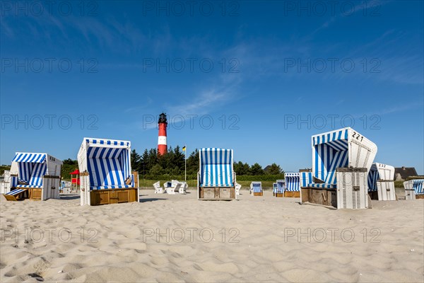 Beach chairs on the beach in front of the lighthouse