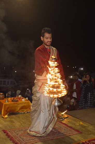 Priest celebrating the Aarti by offering incense