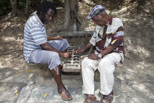 Two local men playing a board game called Warri