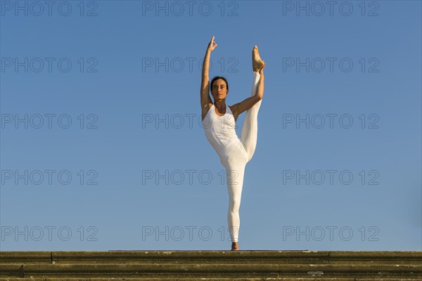 Young woman practising Hatha yoga