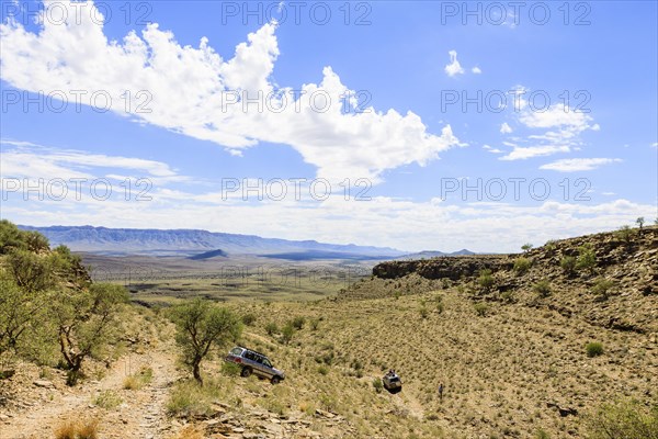 SUV driving through arid landscape