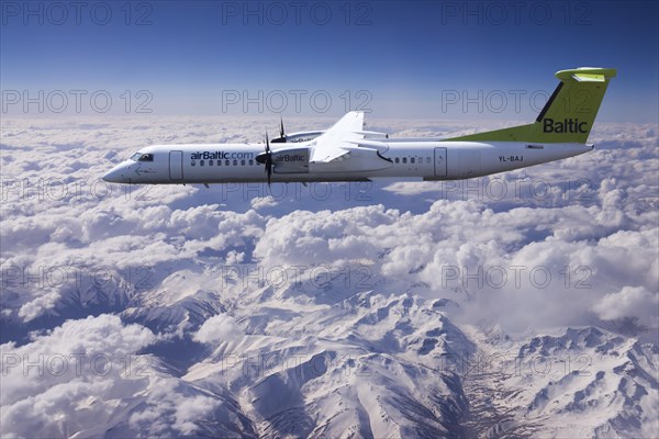 Aircraft YL-BAJ Air Baltic De Havilland Dash 8 in flight above the Alps