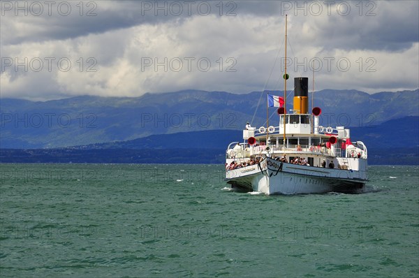 Paddle steamer Simplon on Lake Geneva or Lac Leman with storm clouds