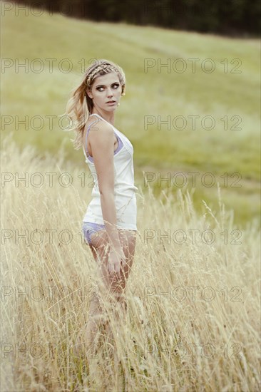 Young woman in lingerie posing outdoors