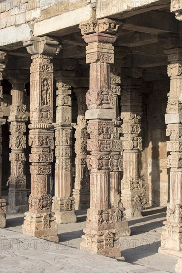 Columns with carvings at Quwwat ul-Islam Mosque