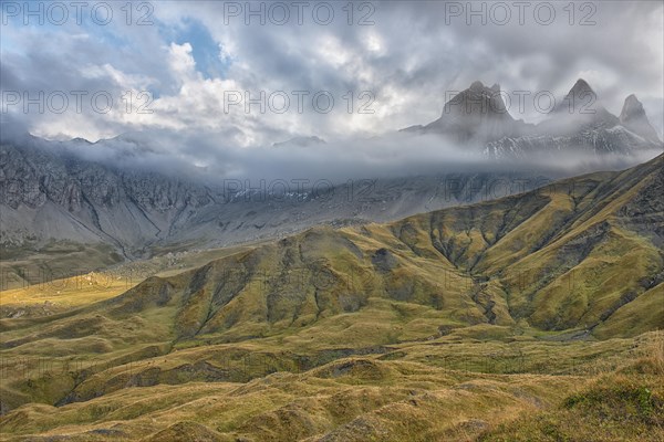 Pelvoux landscape with the Les Aiguilles d'Arves mountain between fog and clouds