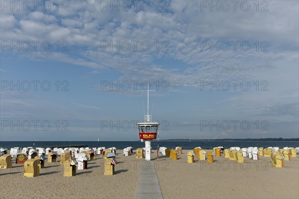 Empty sandy beach with beach chairs and DLRG-lifeguard tower