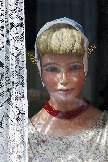 Display dummy in Dutch traditional costume in a window