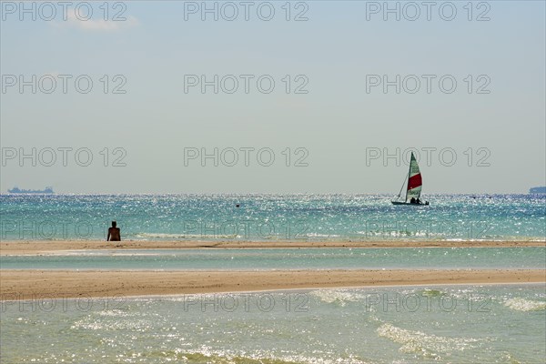 Sailboat on sparkling sea