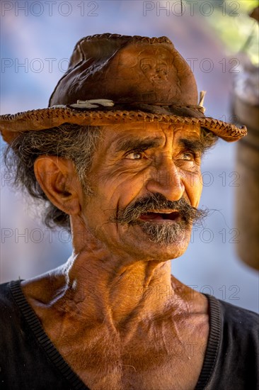 Sugar cane farmer wearing a hat