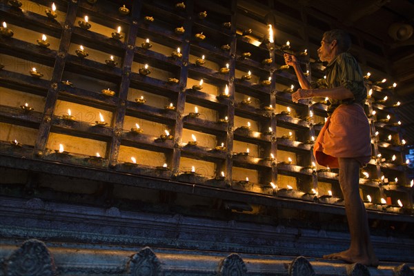 Man lighting an oil lamp