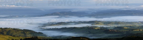 Maremma panorama view from Castiglioncello Bandini at sunrise with morning fog