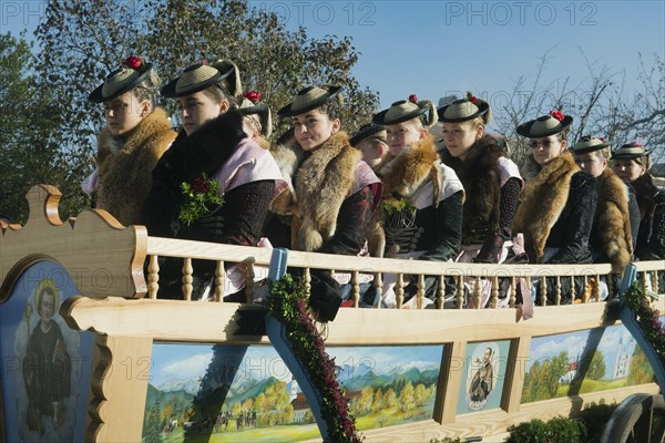 Women in a carriage wearing traditional costume