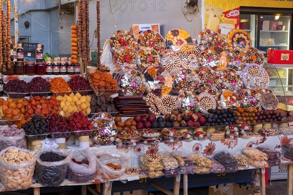 Stall in market hall with candied fruits