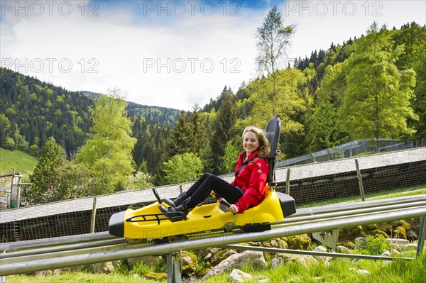 Young woman on a summer toboggan run