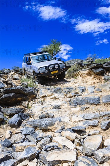 SUV driving down rock steps