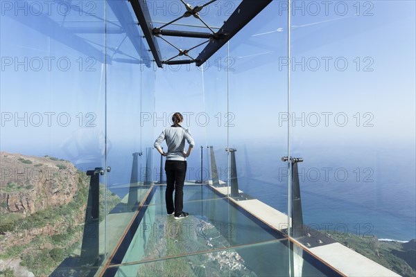 Woman taking in the view of the village of Agulo from the restaurant Mirador de Abrante