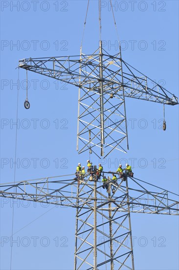 Overhead linemen working on a pylon