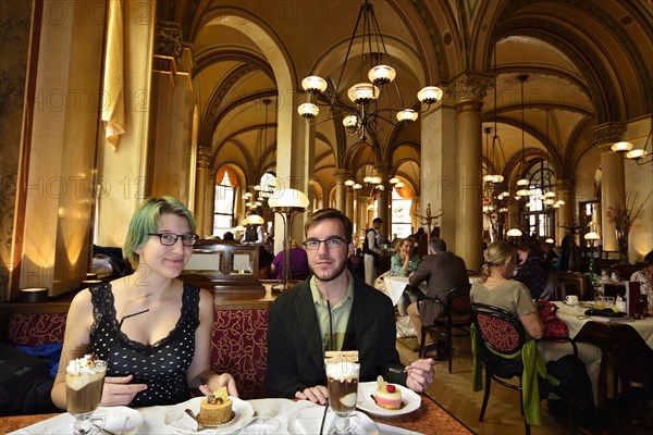 Young couple sitting at a table in the traditional Cafe Central