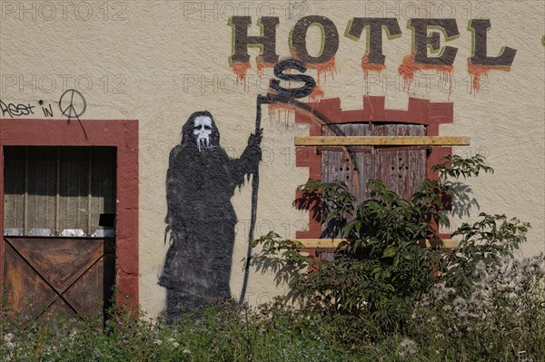 Abandoned hotel with graffiti of the Reaper