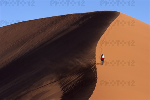 Man walking on the dune crest of Dune 45