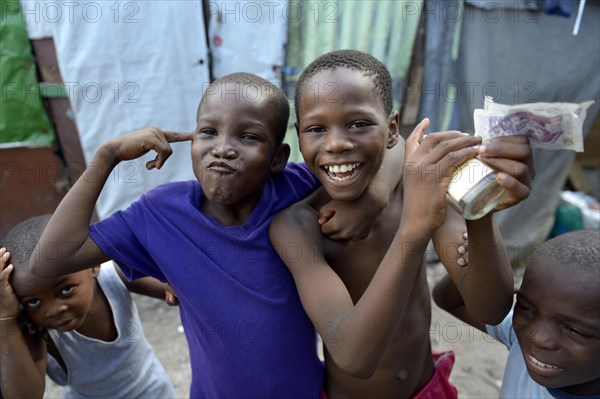 Two boys posing with money