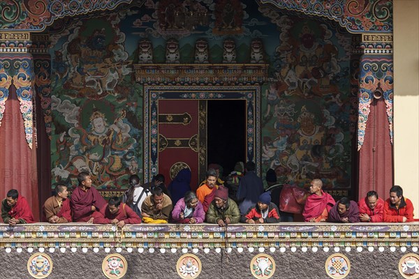 Native people on the balcony of the Cinya Llama Gompa