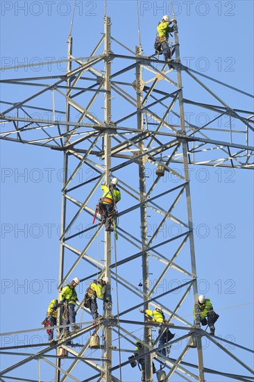 Overhead linemen working on a pylon