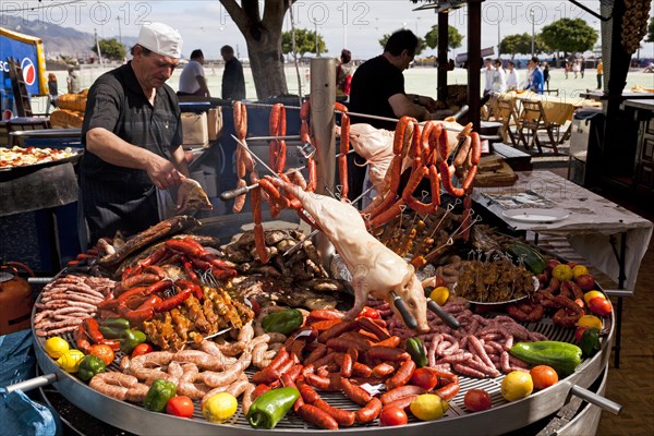 BBQ stand with suckling pig and sausages