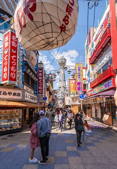 Many colorful advertising signs in a pedestrian zone with shops and restaurants