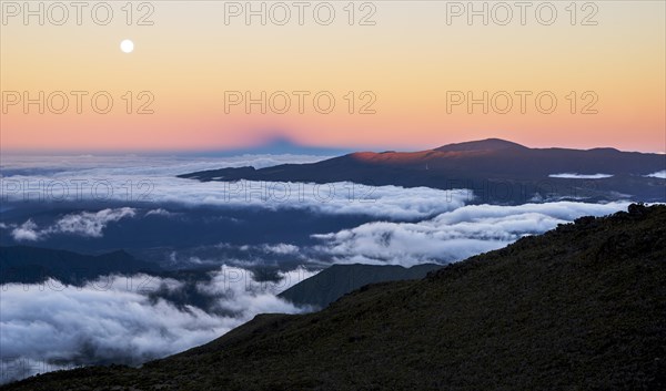 Moonrise and sunset over the Piton de la Fournaise volcano