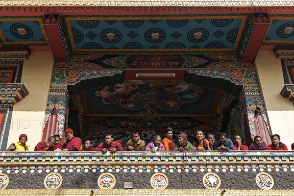 Native people on the balcony of the Cinya Llama Gompa