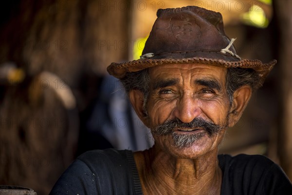 Sugar cane farmer wearing a hat