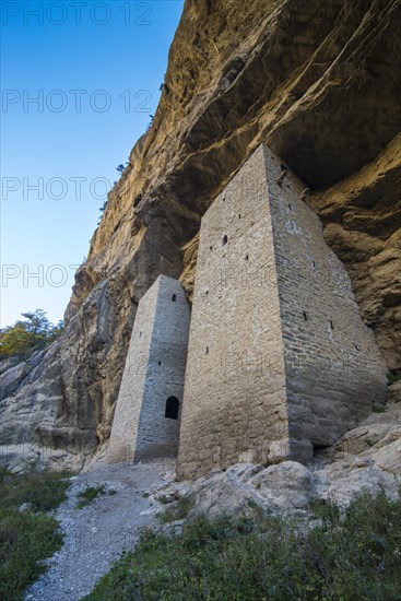 Chechen watchtowers under overhanging cliff on the Argun river