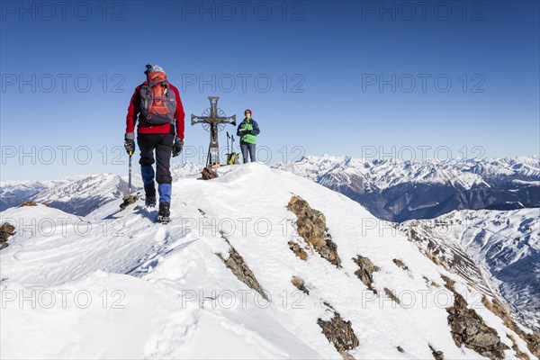 Mountaineer on the summit of Mt Penser Weisshorn above Penser Joch in Sarn Valley